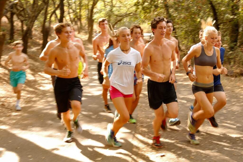 Sonoma Academy runners (front row, from right) Rylee Bowen, Caleb Richards and McKenna Sell lead the way during a Sonoma Academy cross-country team workout at Howarth Park in Santa Rosa on Wednesday. (ALVIN JORNADA / The Press Democrat)