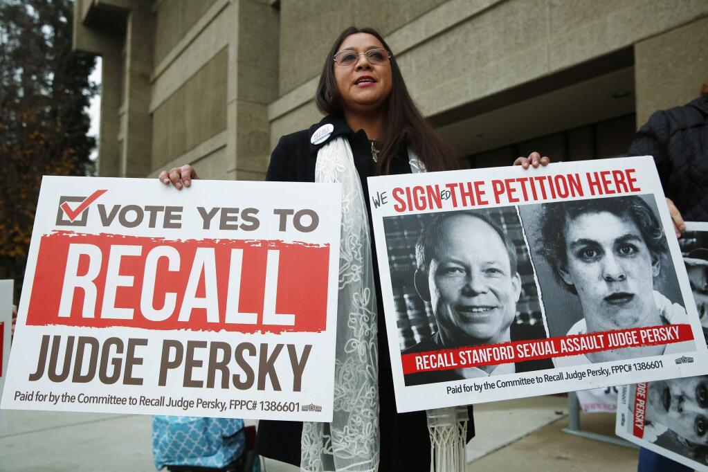 Ana Gabriela Hermosillo joins in a protest calling for the recall of Santa Clara County Judge Aaron Persky at the Santa Clara County Registrar of Voters office in San Jose, Calif., Thursday, Jan. 11, 2018. (Gary Reyes/San Jose Mercury News via AP)