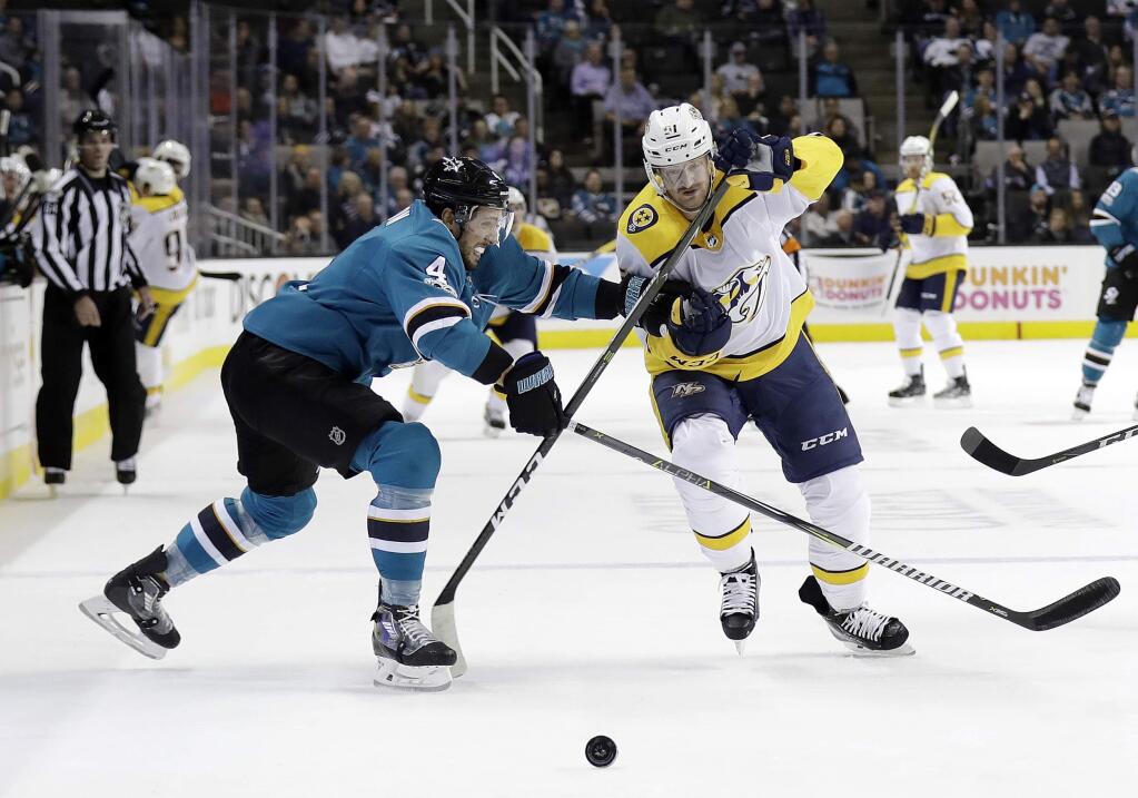 The Nashville Predators' Austin Watson, right, is defended by the San Jose Sharks' Brenden Dillon during the first period Wednesday, Nov. 1, 2017, in San Jose. (AP Photo/Marcio Jose Sanchez)