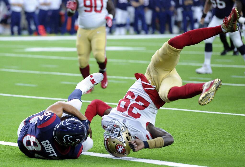 San Francisco 49ers safety Jaquiski Tartt (29) flips after tackling Houston Texans tight end Ryan Griffin (84) during the first half of a preseason NFL football game Saturday, Aug. 18, 2018, in Houston. (AP Photo/George Bridges)