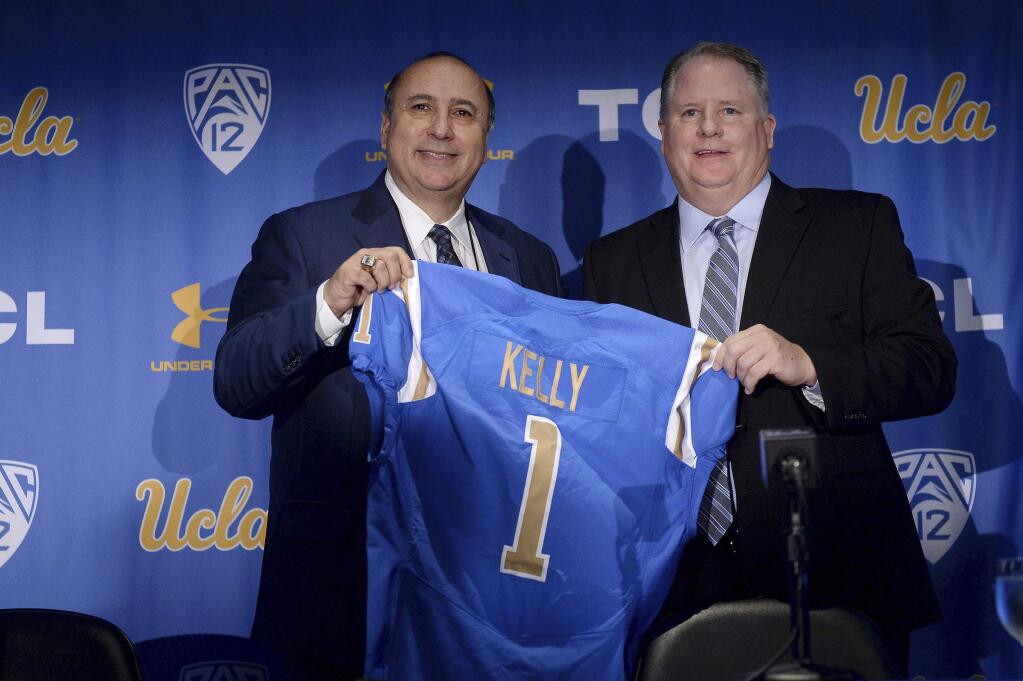 New UCLA head football coach Chip Kelly, right, and Director of Athletics Dan Guerrero pose for a photo during a news conference on the UCLA campus at Pauley Pavilion, Monday, Nov. 27, 2017. (Hans Gutknecht/Los Angeles Daily News via AP)