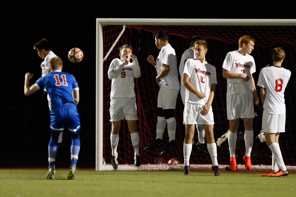 A free kick early in the first half by Tamalpais' Oliver Parkin (11) sails high over the goal, past the Montgomery wall during the NCS Division 2 tournament boys varsity soccer match between Tamalpais and Montgomery high schools in Santa Rosa, California on Wednesday, February 15, 2017. (Alvin Jornada / The Press Democrat)