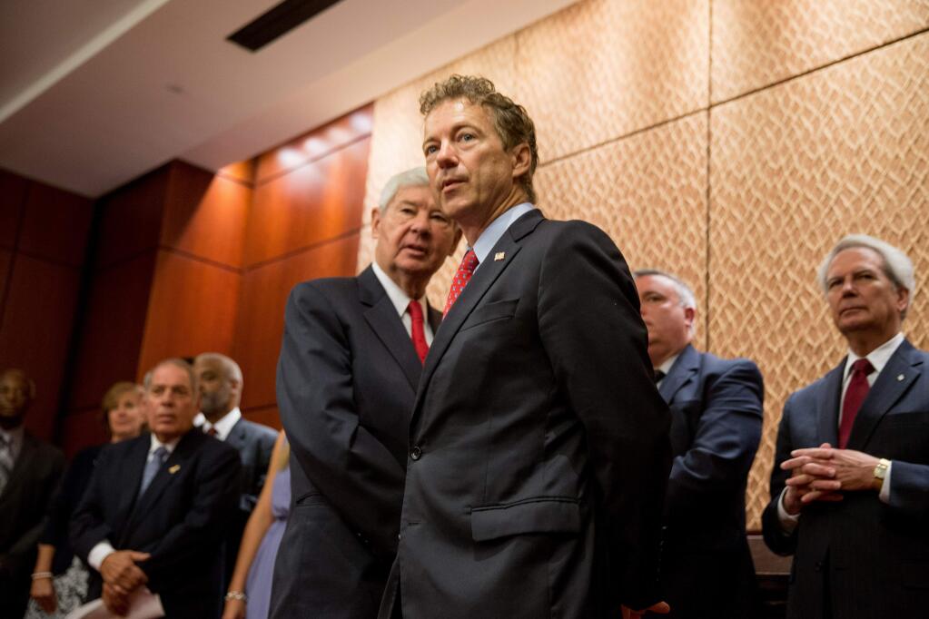 Republican presidential candidate, Sen. Rand Paul, R-Ky. and former Florida Sen. Bob Graham take questions from the audience during a news conference on Capitol Hill in Washington, Tuesday, June 2, 2015, to call for the 28 classified pages of the 9-11 report to be declassified. Paul has been voicing his dissent in the Senate against a House bill backed by the president that would end the National Security Agency's collection of American calling records while preserving other surveillance authorities. (AP Photo/Andrew Harnik)