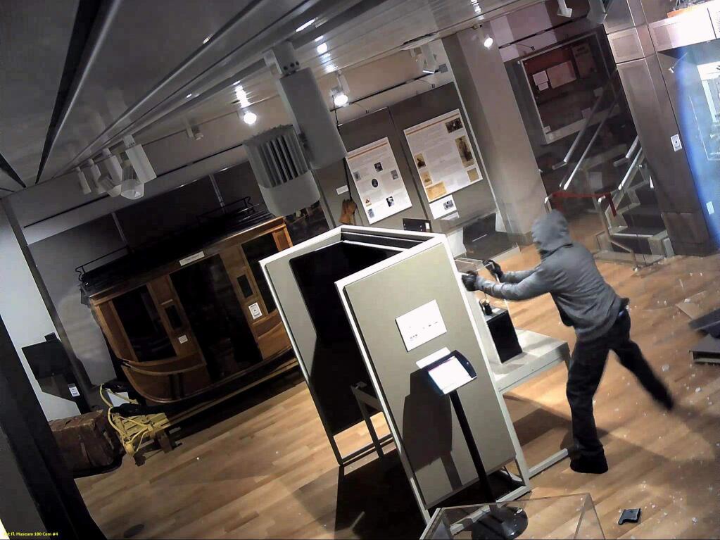 In this image from surveillance video released by the FBI, a suspect is seen inside of the Wells Fargo Museum on Tuesday, Jan. 27, 2015 in San Francisco. Officials vowed to reopen the popular history museum in the heart of San Francisco's financial district after thieves smashed a stolen vehicle through its front door and made off with historic gold nuggets on display. (AP Photo/FBI)