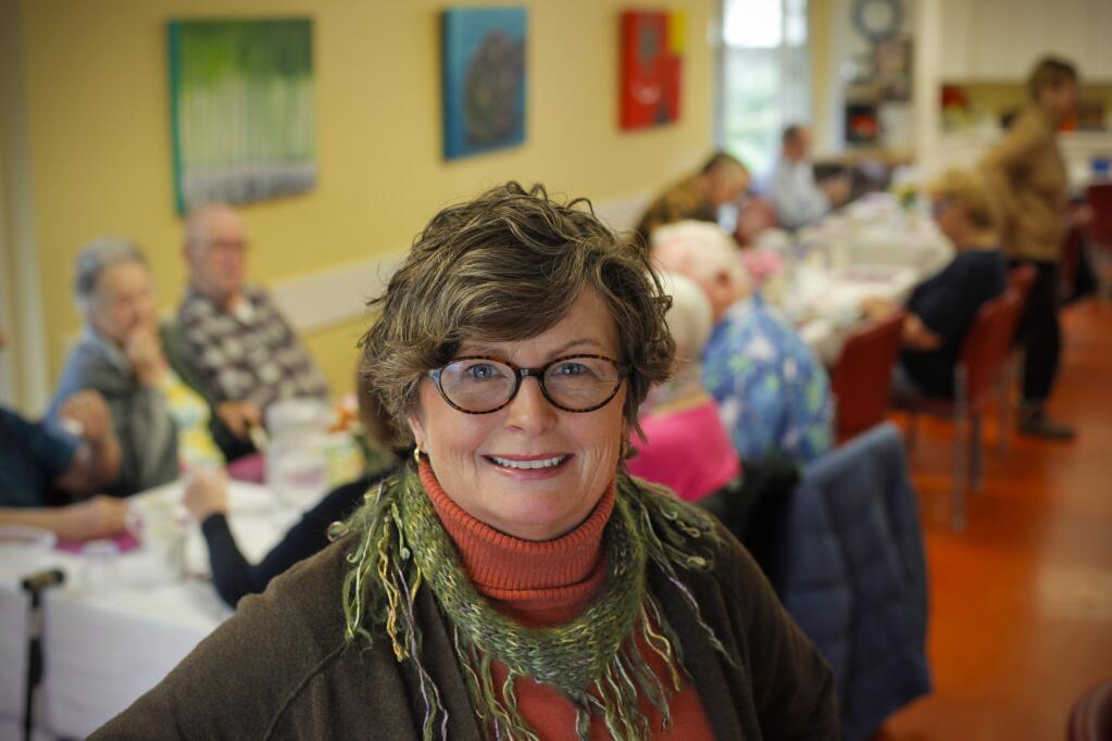 Elece Hempel, Executive Director of Petaluma People Services Center visits with lunch guests of the Senior Cafe at the Petaluma Senior Center in Lucchesi Park. (CRISSY PASCUAL/ARGUS-COURIER STAFF)
