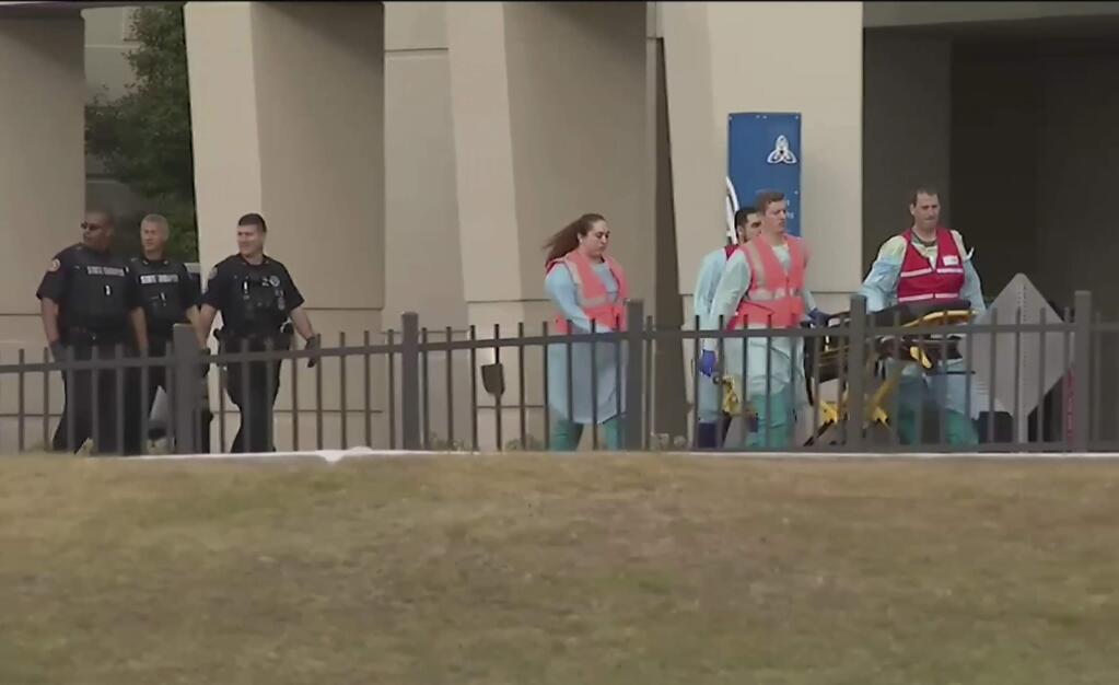 This photo taken from video provided by WEAR-TV shows emergency responders near the Naval Air Base Station in Pensacola, Fla., Friday, Dec. 6, 2019. The US Navy is confirming that an active shooter and one other person are dead after gunfire at the Naval Air Station in Pensacola. Area hospital representatives tell The Associated Press that at least 11 people were hospitalized. The base remains locked down amid a huge law enforcement response.  (WEAR-TV via AP)