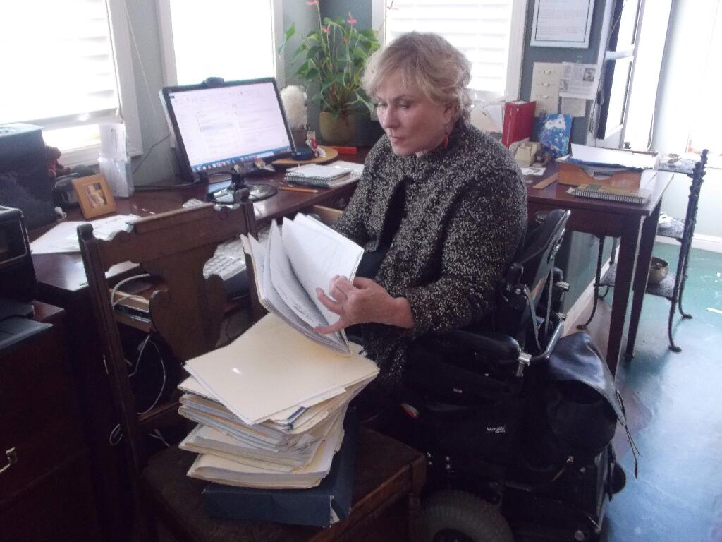 PHOTO: 1 by LESA TANNER-HolLynn D'Lil at home in Graton with a stack of folders full of letters she has written since 1993 asking businesses to remove barriers to accessibility.