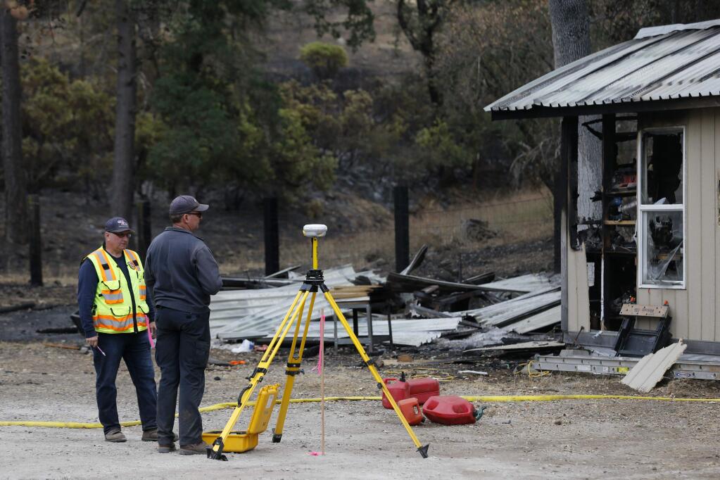 CalFire investigators collect information at the residence where the Valley Fire started on High Valley Rd. Photo taken on Tuesday, September 15, 2015 in Cobb, California. (BETH SCHLANKER/ The Press Democrat)