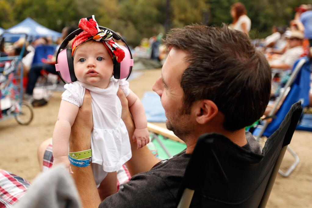 Chris Conklin of San Francisco holds his 4-month-old daughter Eleanor as she experiences her first concert, during the Russian River Jazz and Blues Festival in Guerneville, California on Saturday, September 12, 2015. (Alvin Jornada / The Press Democrat)