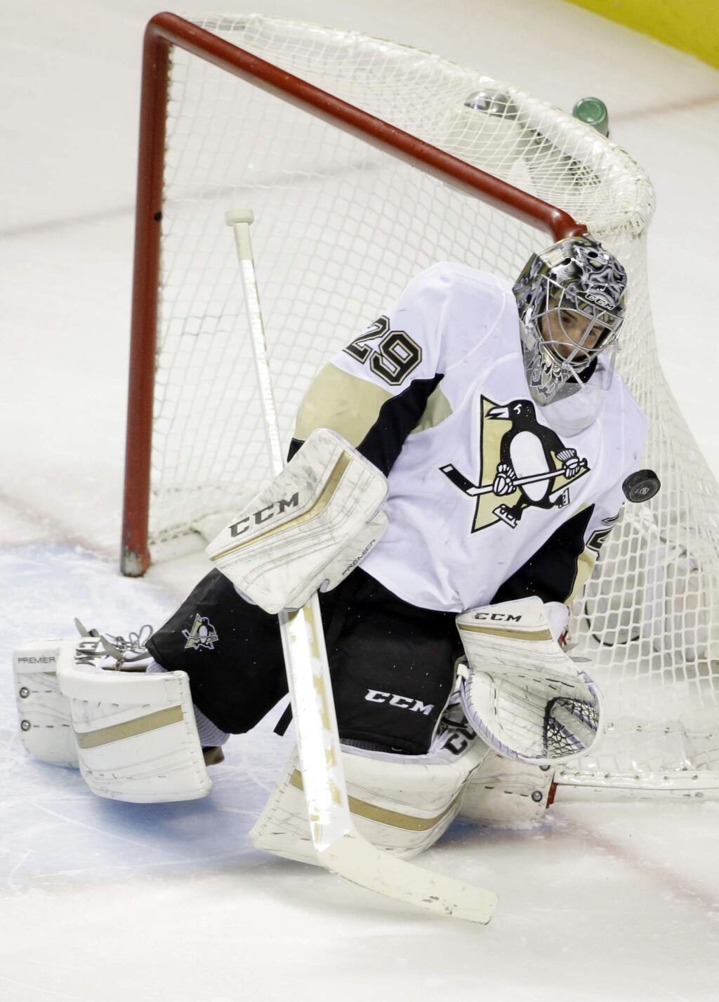 Pittsburgh Penguins goalie Marc-Andre Fleury (29) stops a shot on goal against the San Jose Sharks during the first period of an NHL hockey game Tuesday, Dec. 1, 2015, in San Jose, Calif. (AP Photo/Marcio Jose Sanchez)