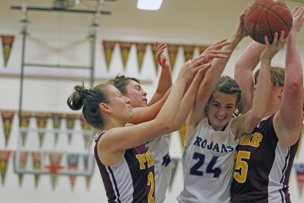 DWIGHT SUGIOKA/FOR THE ARGUS-COURIERPetaluma High's Jaden Krist is crunched by Piner defenders as she grabs a rebound. Jaden and the T-Girls survived a Piner fourth-quarter comeback.