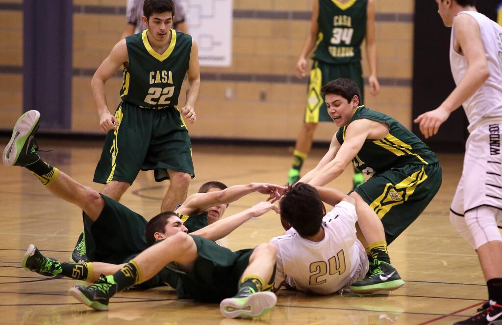 Casa Grande fights for a loose ball with Windsor's Gabe Knight during the game held at Windsor High School, Thursday, February 5, 2015. (Crista Jeremiason / The Press Democrat)