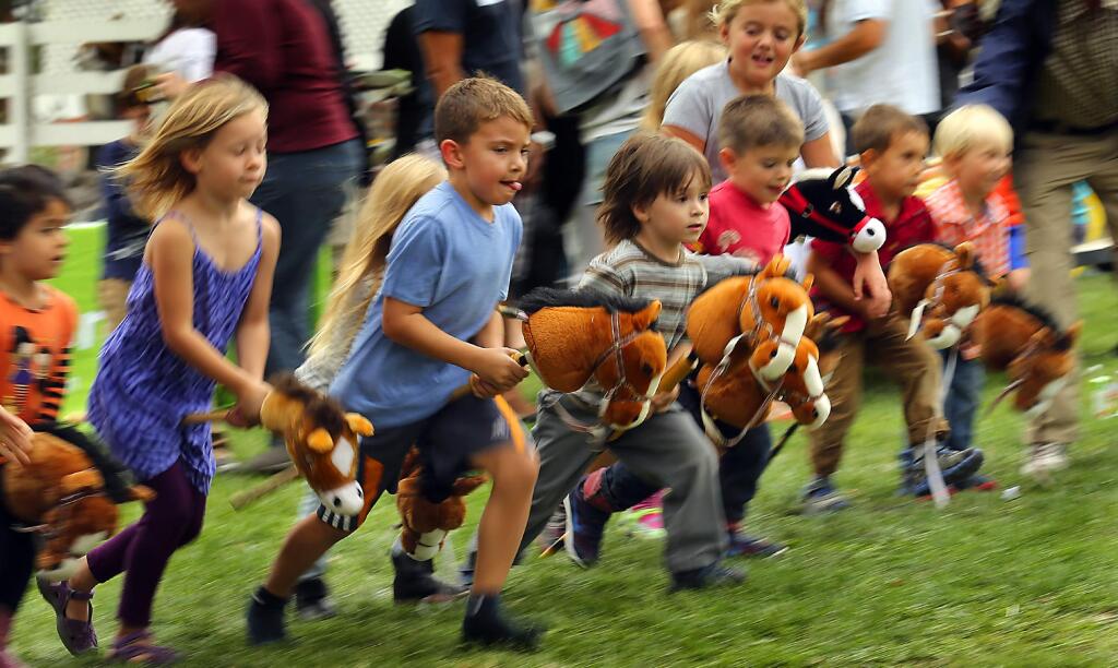The frenzied start of the hobby horse races at the Tolay Fall Festival 2015. (JOHN BURGESS / The Press Democrat)