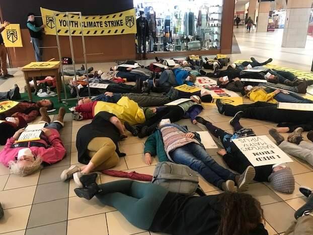 Students stage a 'die-in' at Santa Rosa Plaza in Santa Rosa as part of the Youth Climate Strike on Friday, Dec. 6, 2019. (AUSTIN MURPHY / The Press Democrat)