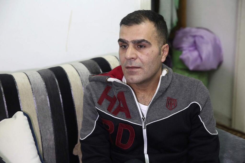 Ammar Sawan, 40, a Syrian refugee from Moadamiyeh, outside Damascus, speaks during an interview in his family's home in Amman, Jordan on Sat. Jan. 28, 2017. Sawan and his family took their first step toward resettlement in the United States three months ago, submitting to an initial round of security screenings. His dreams of a better life were crushed when President Donald Trump issued an indefinite ban on displaced Syrians entering the United States. (AP Photo/Sam McNeil)