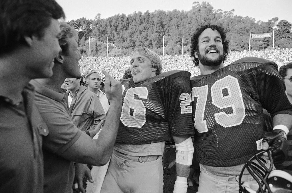 Cal's Kevin Moen (26) and Keith Kartz (79) are all smiles after Cal defeated Stanford 25-20 on Nov. 20, 1982 following 'The Play' in the Big Game. Moen weaved his way through hundreds of people and scored a touchdown after time had run out to give Cal the win. (AP Photo/Carl Viti)