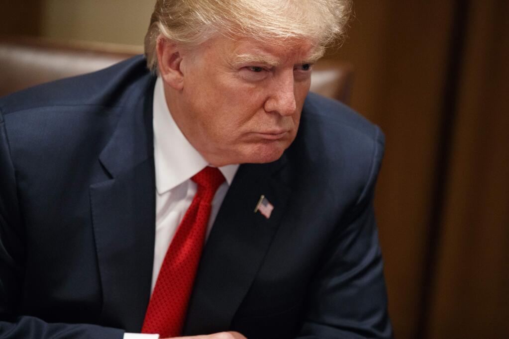 President Donald Trump listens during a meeting with law enforcement officials on the MS-13 street gang and border security, in the Cabinet Room of the White House, Tuesday, Feb. 6, 2018, in Washington. (AP Photo/Evan Vucci)