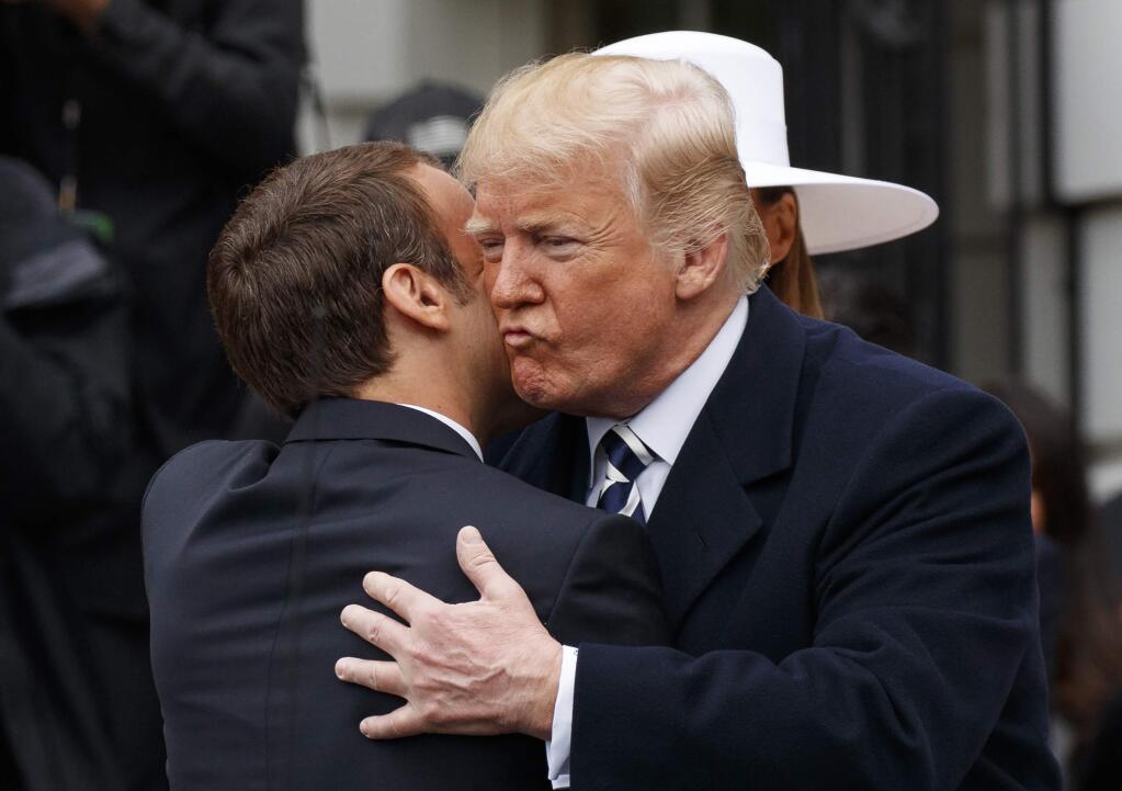 President Donald Trump greets French President Emmanuel Macron as he arrives for a State Arrival Ceremony on the South Lawn of the White House in Washington, Tuesday, April 24, 2018. (AP Photo/Carolyn Kaster)