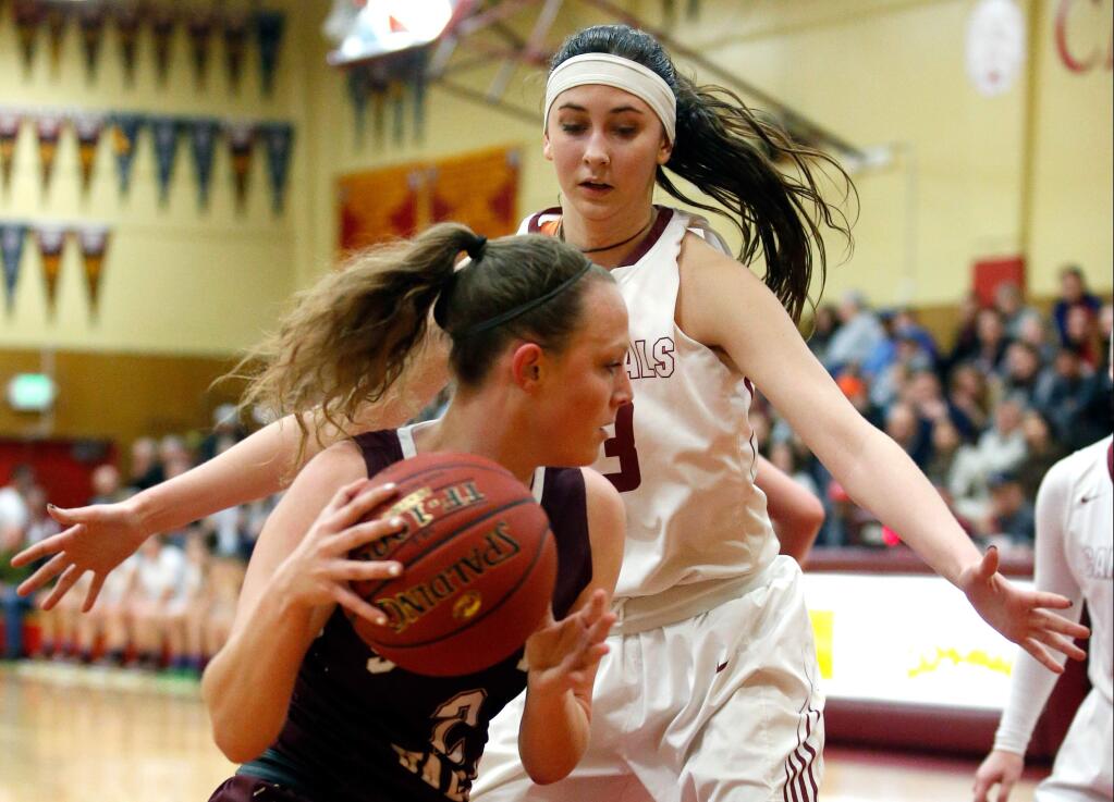 Cardinal Newman's Hailey Vice-Neat (13), right, defends against Scotts Valley's Shasta Smith (2) during the first half of the CIF NorCal girls basketball playoff game between Scotts Valley and Cardinal Newman high schools in Santa Rosa, California on Saturday, March 12, 2016. (Alvin Jornada / The Press Democrat)