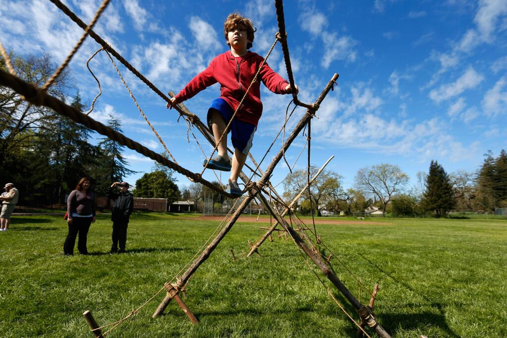 Pack 8 tiger scout Jack Fahey, 6, steadily walks along a rope bridge during the Scout-O-Rama presented by the Redwood Empire Council of the Boy Scouts of America in Santa Rosa, California on Saturday, March 19, 2016. (Alvin Jornada / The Press Democrat)