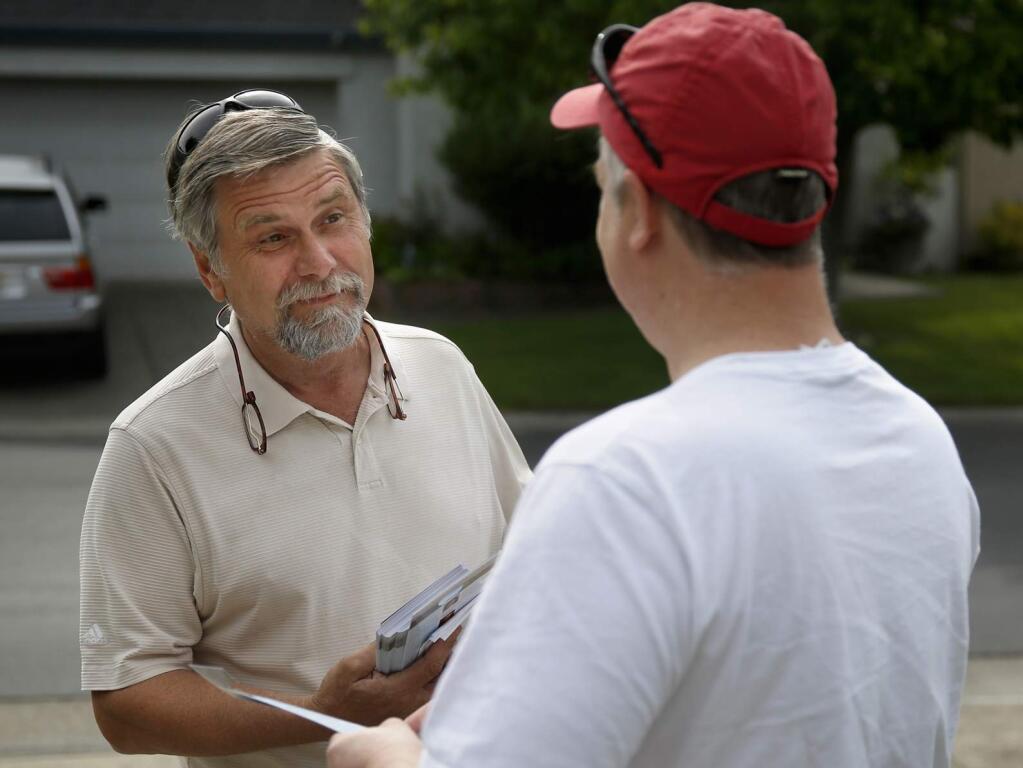 David Sundstrom, left, the current Sonoma County Auditor-Controller Treasurer Tax Collector, talks with Petaluma resident Joe Howard about his candidacy in the June 2014 election. Photo taken in Petaluma, on Sunday, May 4, 2014. (BETH SCHLANKER/ The Press Democrat)