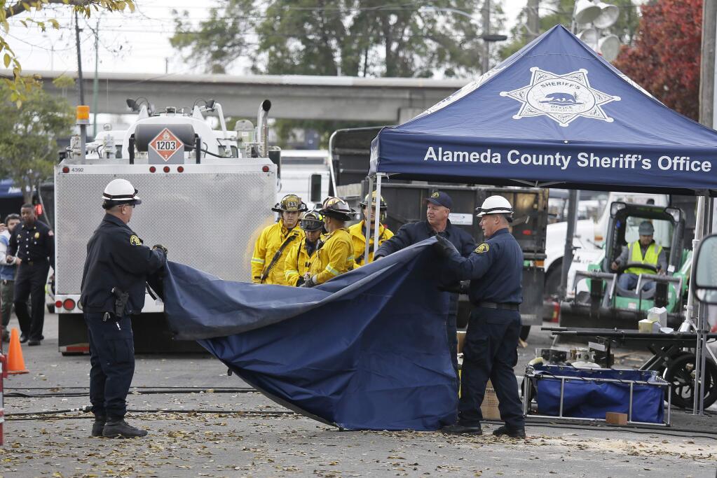 Members of the Alameda County Sheriff's Office pack up gear outside the site of a warehouse fire Wednesday, Dec. 7, 2016, in Oakland, Calif. Recovery efforts at the site have ended officials said Wednesday. (AP Photo/Eric Risberg)