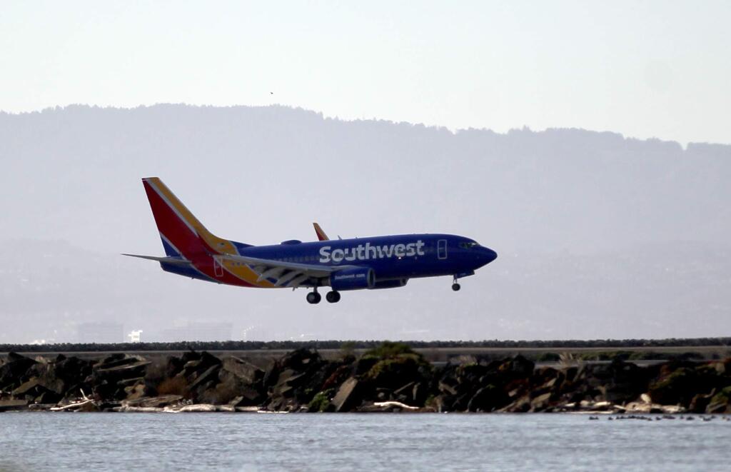 Southwest Airlines Flight 2547 makes an emergency landing after circling for several hours at Oakland International Airport in Oakland, Calif., on Wednesday, Dec. 23, 2015. The flight made what appeared to be a normal landing after circling for several hours over an Oakland, California, airport due to possible landing gear problems. (Anda Chu/Bay Area News Group via AP) STAND ALONE NEWS/LOCALS PLEASE CREDIT/MAGS OUT