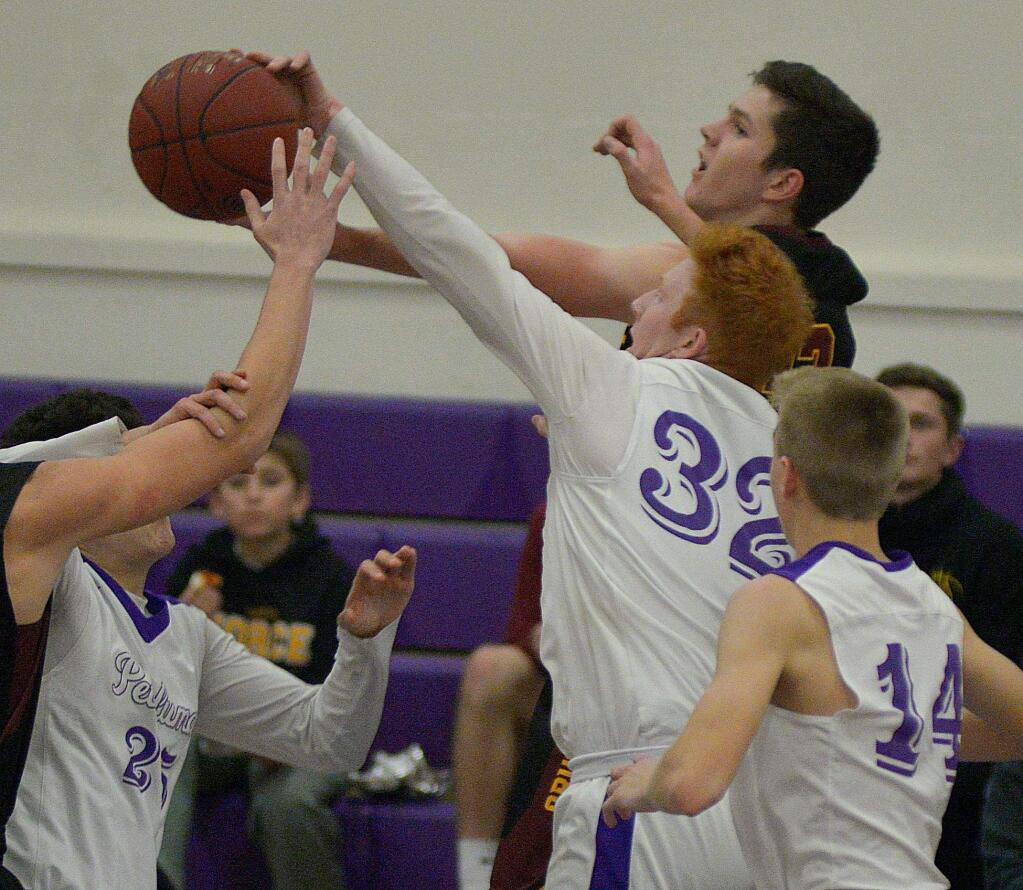 SUMNER FOWLER/FOR THE ARGUS-COURIERPetaluma's Sam Brown (32) battles through a crowd to block a Vintage shot as Eric Perez (25) arrives to help.