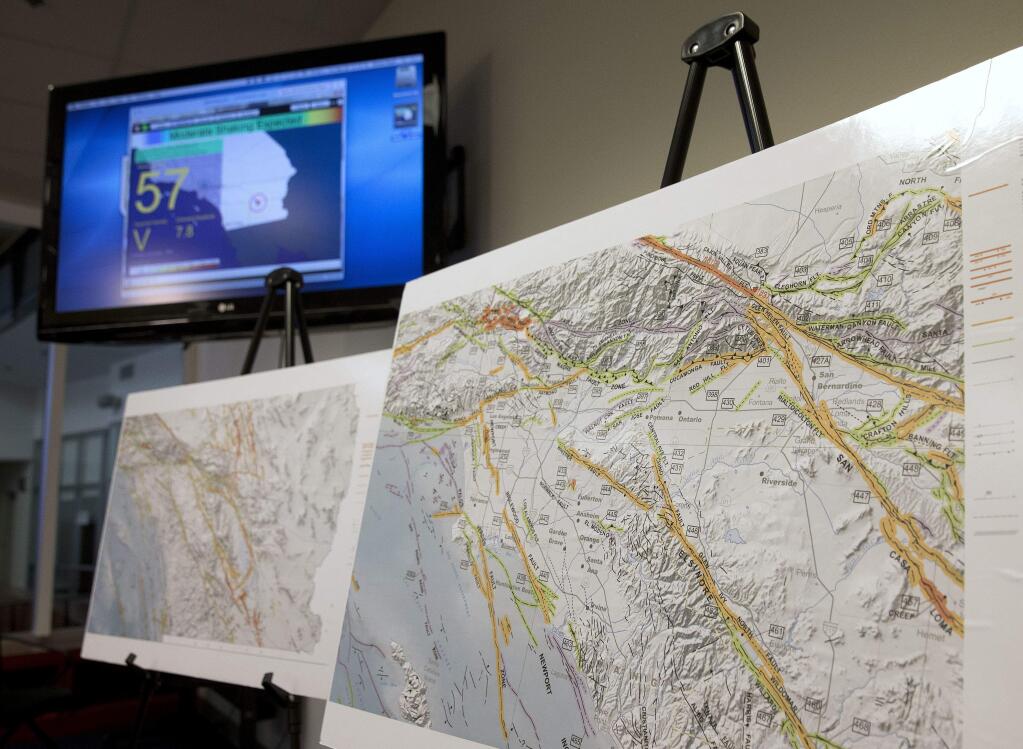 A map of earthquake faults in part of Southern California is seen as a sample of an earthquake early warning system the state that is under development is displayed on a television monitor in the background, during a news conference Thursday, Sept. 29, 2016, in Rancho Cordova, Gov. Jerry Brown has signed legislation to develop a statewide earthquake early warning system in California, after devoting $10 million to the program in the state budget he signed this year. (AP Photo/Rich Pedroncelli)