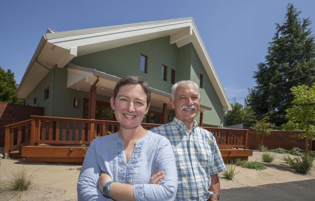 Lolly and Darrel Jones at the energy efficient house they designed on Patten Street. Lolly's 'the best electrician I've ever worked with,' says proud dad. (Photo by Robbi Pengelly/Index-Tribune)