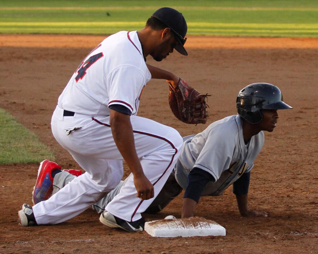 Bill Hoban/Index-TribuneStompers first-baseman Daniel Baptiste tries to tag a Vallejo runner during a recent game.