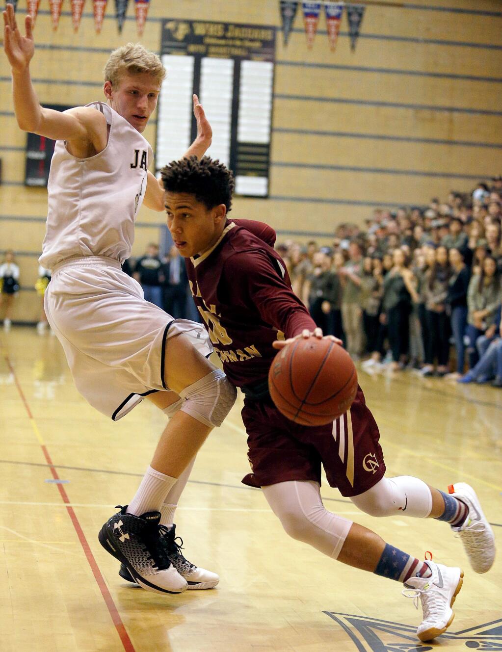 Cardinal Newman's Damian Wallace (10), right, drives to the basketb around Windsor's Riley Smith (33) during the second half of a boys varsity basketball game between Cardinal Newman and Windsor high schools in Windsor, California on Thursday, January 19, 2017. (Alvin Jornada / The Press Democrat)