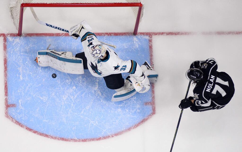 San Jose Sharks goalie Martin Jones, left, stops a shot as Los Angeles Kings center Jordan Nolan stands by during the third period Wednesday, Jan. 18, 2017, in Los Angeles. The Sharks won 3-2. (AP Photo/Mark J. Terrill)