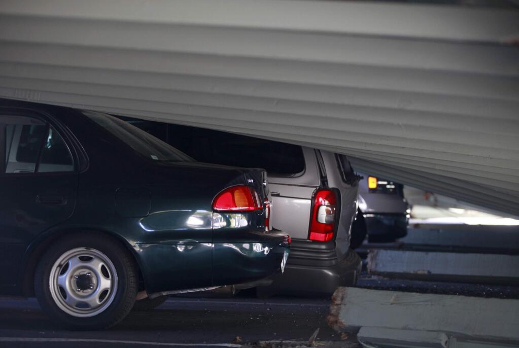 Cars were crushed by a parking structure that collapsed at Charter Oaks Apartments during a 6.1 earthquake on Sunday, Aug. 24, 2014 in Napa. (BETH SCHLANKER / The Press Democrat)