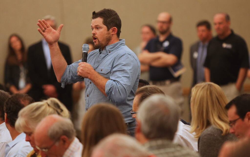 Chris Grabill, a local contractor, addresses the panel during a Rebuild NorthBay community meeting at SSU, in Rohnert Park on Wednesday, October 25, 2017. (Christopher Chung/ The Press Democrat)