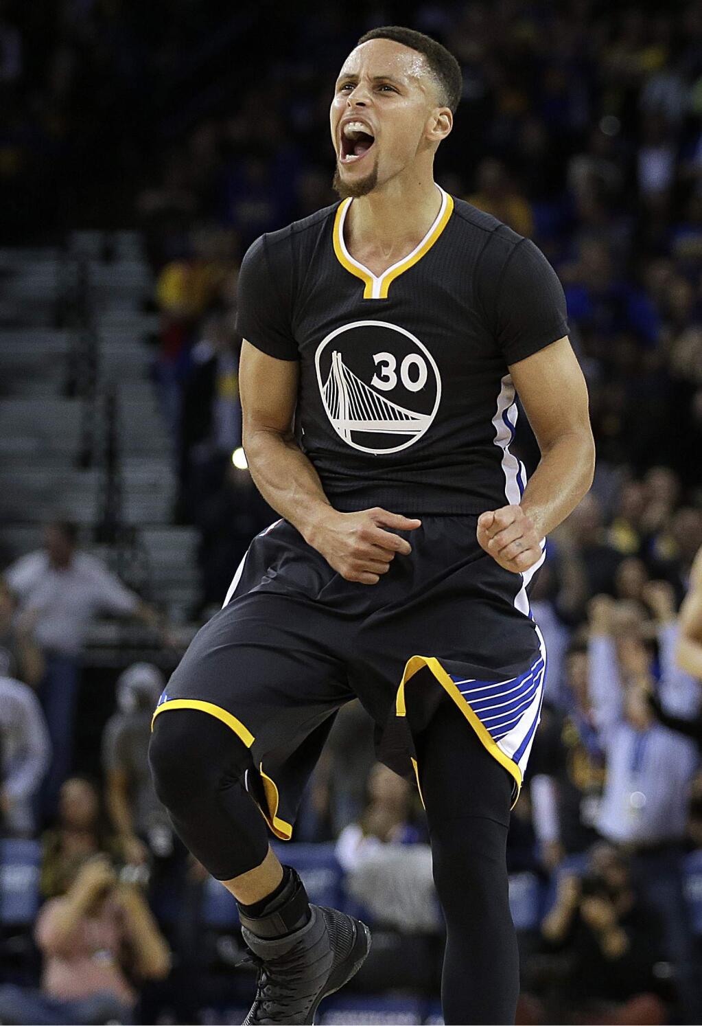 FILE - In this March 12, 2016, file photo, Golden State Warriors' Stephen Curry celebrates a score against the Phoenix Suns in the final seconds of an NBA basketball game Saturday in Oakland, Calif. Curry is adding a second straight MVP award to his record-setting season, a person with knowledge of the award told The Associated Press, Monday, May 9, 2016. The person spoke on condition of anonymity because the NBA has not revealed the winner. (AP Photo/Ben Margot File)