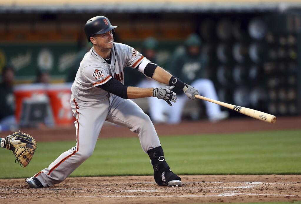 San Francisco Giants' Buster Posey swings for an RBI-single off Oakland Athletics' Edwin Jackson in the fourth inning of a baseball game Friday, July 20, 2018, in Oakland, Calif. (AP Photo/Ben Margot)