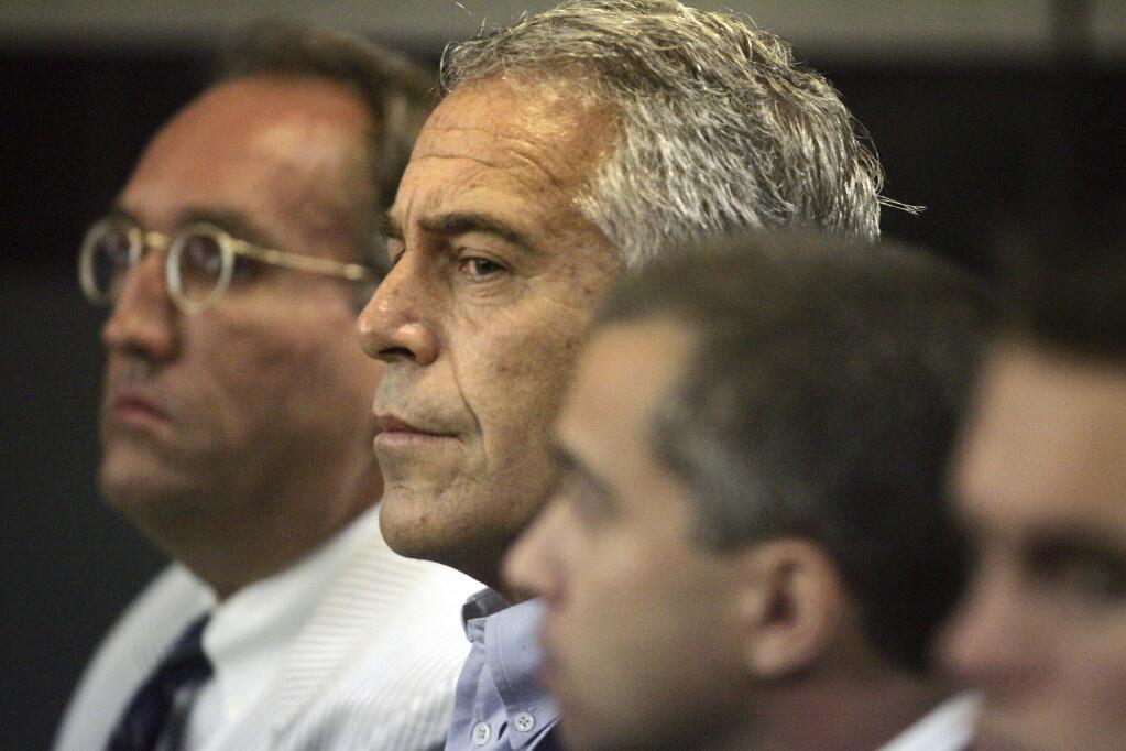 FILE - In this July 30, 2008, file photo, Jeffrey Epstein, center, appears in court in West Palm Beach, Fla. (Uma Sanghvi/Palm Beach Post via AP, File)