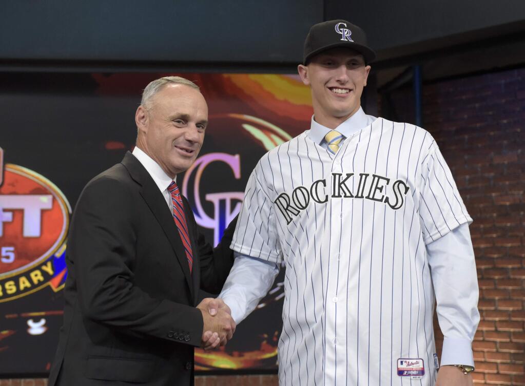 Commissioner of Major League Baseball Rob Manfred, left, poses with pitcher Mike Nikorak from Stroudsburg High School in Stroudsburg, Pa., at the 2015 MLB baseball draft Monday, June 8, 2015, in Secaucus, N.J. Rodgers was chosen by the Colorado Rockies with the 27th selection. (AP Photo/Bill Kostroun)