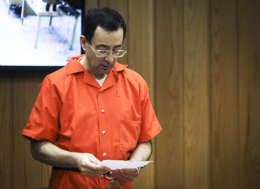 Larry Nassar reads a statement Monday, Feb. 5, 2018, during the third and final day of sentencing in Eaton County Court in Charlotte, Mich., where he will be sentenced on three counts of sexual assault. Nassar already has been sentenced to 40 to 175 years in prison in another county and is starting his time behind bars with a 60-year federal term for child pornography crimes. (Matthew Dae Smith/Lansing State Journal via AP)