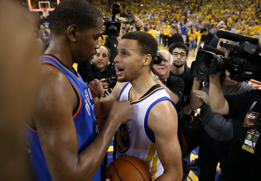 Golden State Warriors' Stephen Curry talks with Oklahoma City Thunder's Kevin Durant following their game in Oakland on Monday, May 30, 2016. The Warriors defeated the Thunder 96-88. (Christopher Chung / The Press Democrat)