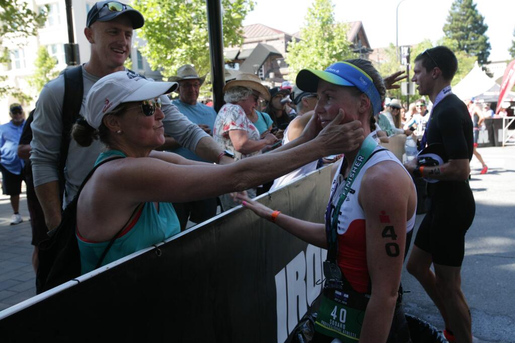 Chelsea Sodaro, the first woman to cross the finish line in the Santa Rosa Ironman competition, gets some love from her mother Marci Snodgrass on Saturday, July 27, 2019 in Santa Rosa, Ca. (Frankie Frost/Special to the (Press Democrat)