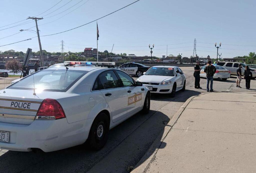 Police cars appear outside Dixon High School Wednesday, May 16, 2018 in Dixon, Ill. Officials say a police officer has shot and wounded a gunman at a northern Illinois high school. The Dixon city manager Danny Langloss says police confronted a former male student with a gun on school property about 8 a.m. Wednesday. Langloss says the gunman shot at an officer who returned fire and hit him. He is in custody with what Langloss described as non-life-threatening injuries. (Rachel Rogers/Sauk Valley Media via AP)