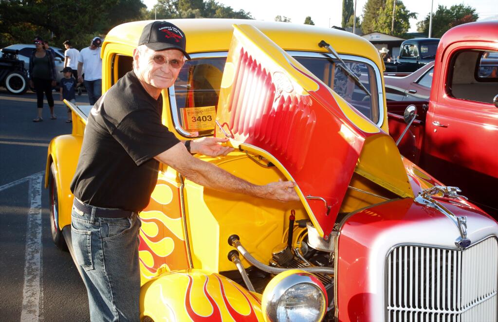 John Buergler Sr. of Cloverdale, lifts the cowling of his 1936 Ford pickup to show off his brightly polished motor at the Cloverdale Car and Motorcycle Show in Cloverdale, California, on Friday, Sept. 7, 2018. (WILL BUCQUOY/ FOR THE PD)