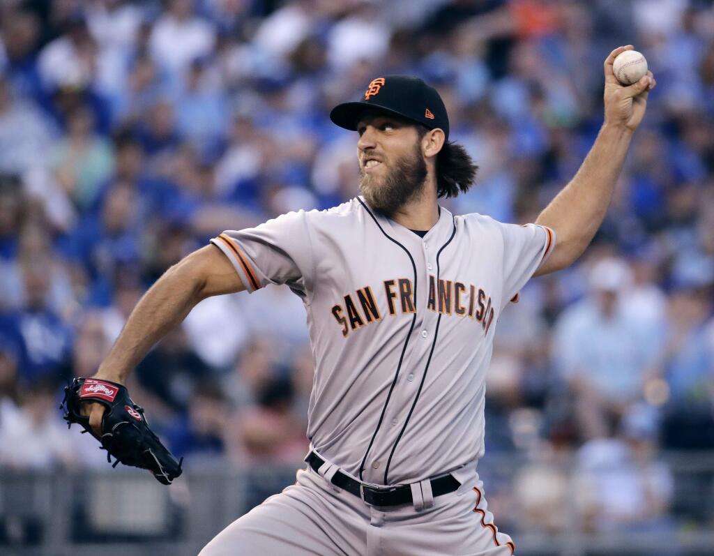 San Francisco Giants starting pitcher Madison Bumgarner throws during the first inning of a baseball game against the Kansas City Royals on Wednesday, April 19, 2017, in Kansas City, Mo. (AP Photo/Charlie Riedel)
