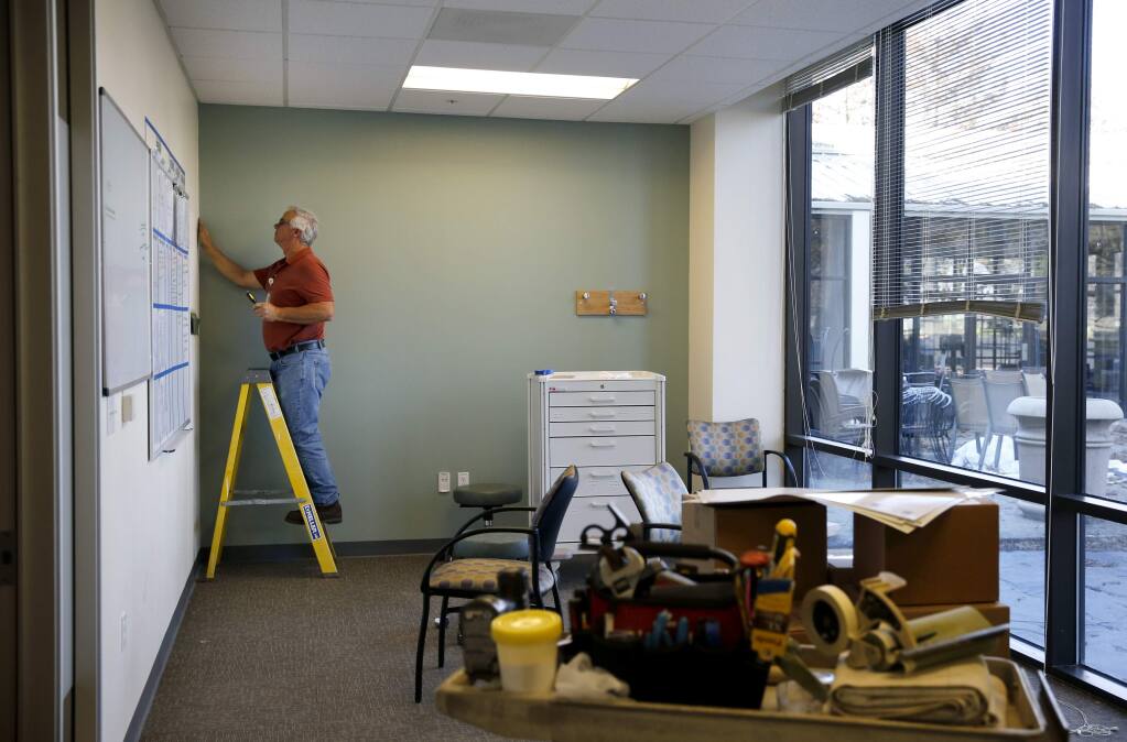 Mark Violetti, a facilities maintenance contractor, works to repair smoke damage in the podiatry and orthopedic offices at the Sutter Pacific Medical Foundation building on Airway Drive in Santa Rosa on Tuesday, Dec. 12, 2017. (BETH SCHLANKER/ The Press Democrat)