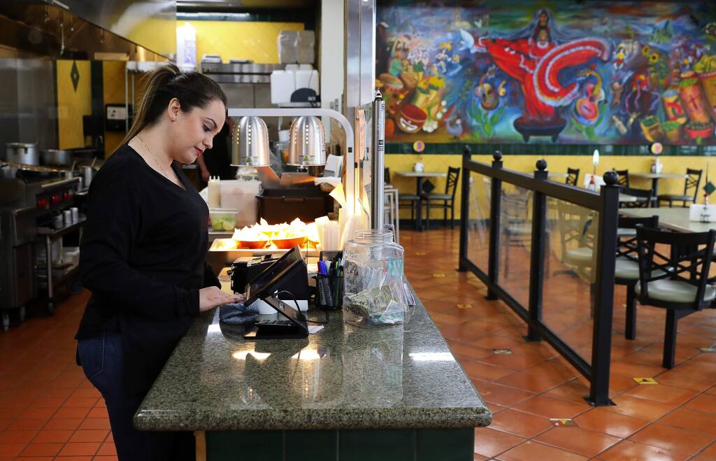 Carolina Padilla, a 22-year-old SSU student, works the register at Pepe's Mexican Restaurant, in the Roseland area of Santa Rosa on Wednesday, January 17, 2018. (Christopher Chung/ The Press Democrat)