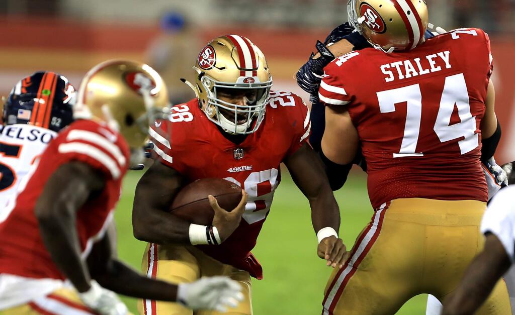 Carlos Hyde gets a good block from lineman Joe Staley as he pops for a first down during the second quarter against the Denver Broncos, Saturday August 19, 2017 at Levi Stadium in Santa Clara. (Kent Porter / The Press Democrat) 2017