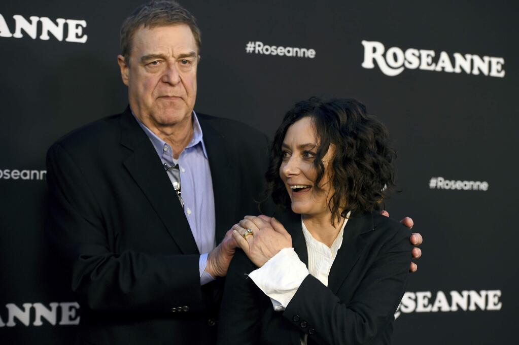 John Goodman, left, and Sara Gilbert arrive at the Los Angeles premiere of 'Roseanne' on Friday, March 23, 2018, in Burbank, Calif. (Photo by Jordan Strauss/Invision/AP)