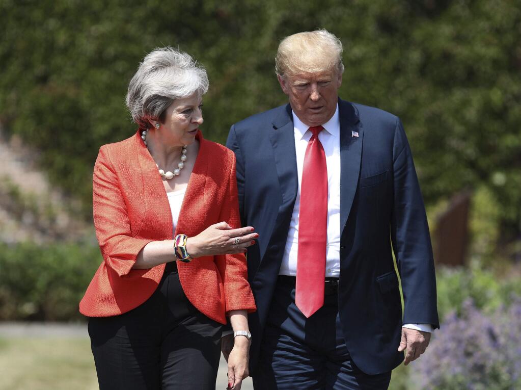 British Prime Minister Theresa May walks with U.S President Donald Trump prior to a joint press conference at Chequers, in Buckinghamshire, England, Friday, July 13, 2018. (Jack Taylor/Pool Photo via AP)